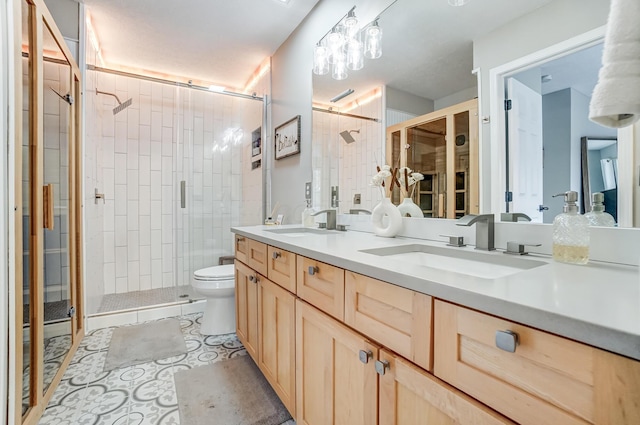 bathroom featuring a stall shower, a sink, and double vanity