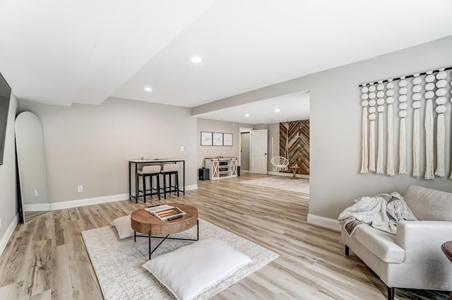 living area with light wood finished floors, recessed lighting, and baseboards