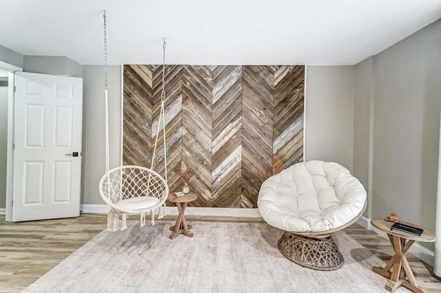 living area featuring baseboards and wood finished floors