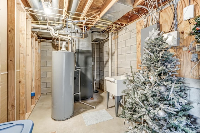 utility room with water heater and a sink