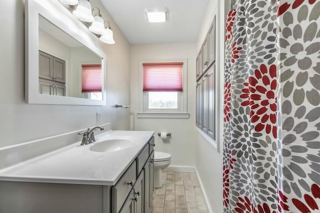 bathroom with toilet, vanity, baseboards, a shower with curtain, and wood tiled floor