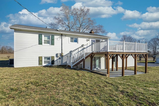 rear view of house featuring a deck, stairway, a lawn, a chimney, and a patio area