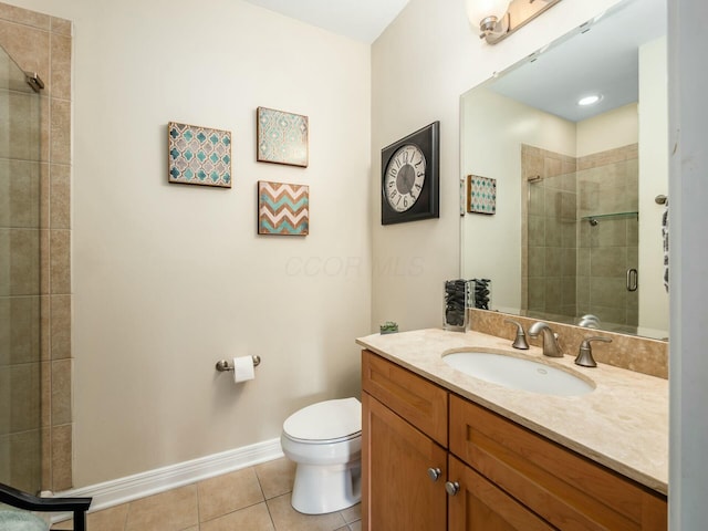 full bath featuring toilet, a stall shower, vanity, tile patterned flooring, and baseboards