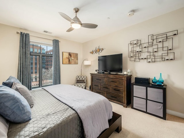 bedroom featuring light colored carpet, visible vents, ceiling fan, and baseboards