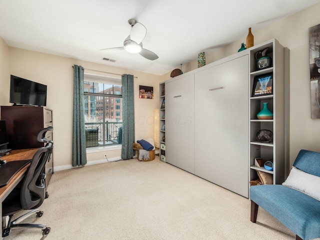 carpeted home office featuring visible vents, ceiling fan, and baseboards