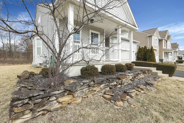 view of property exterior featuring covered porch