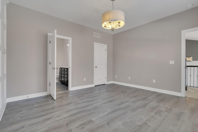 interior space featuring visible vents, baseboards, and wood finished floors