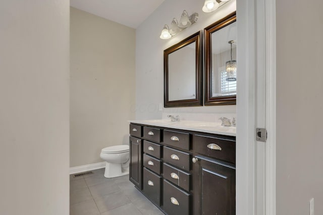 bathroom featuring tile patterned flooring, toilet, a sink, visible vents, and double vanity