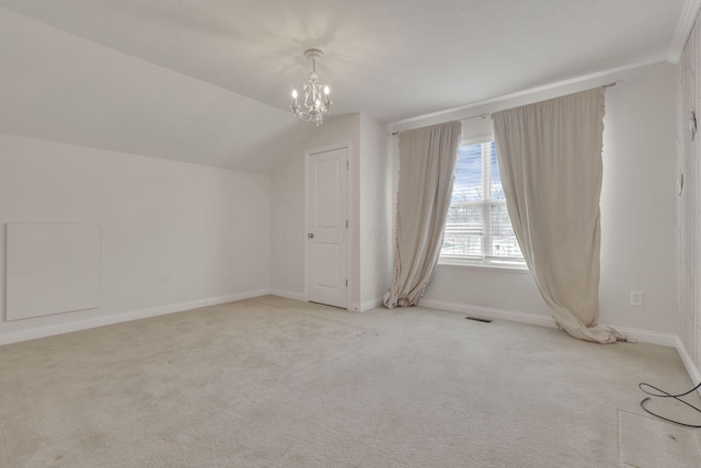 additional living space featuring lofted ceiling, light colored carpet, visible vents, an inviting chandelier, and baseboards