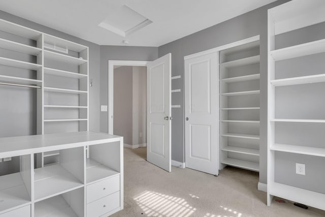 interior space featuring light carpet and attic access