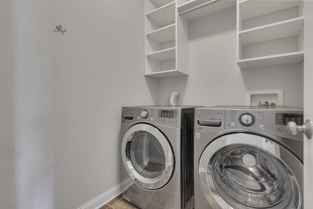 laundry room featuring laundry area, independent washer and dryer, tile patterned flooring, and baseboards