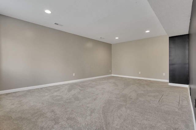 unfurnished room featuring carpet, visible vents, baseboards, and recessed lighting