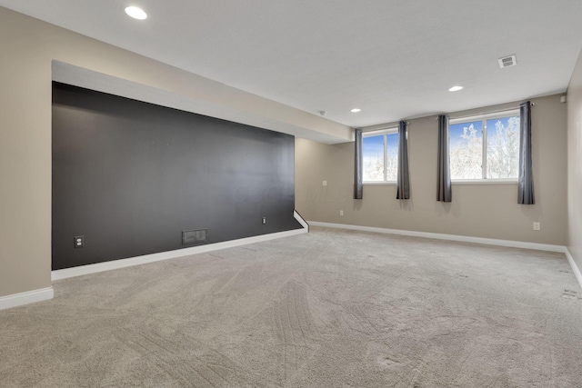 empty room with carpet, visible vents, baseboards, and recessed lighting