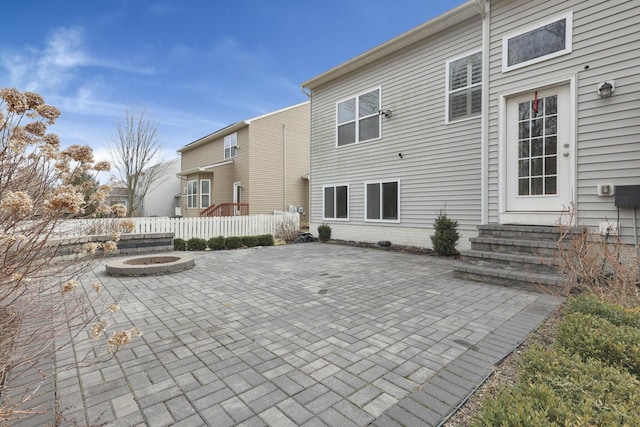 rear view of house featuring a fire pit, a patio, and entry steps