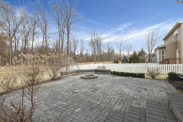 view of patio with a fire pit and fence