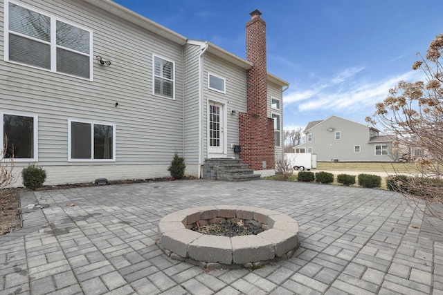 back of house featuring a patio and a chimney