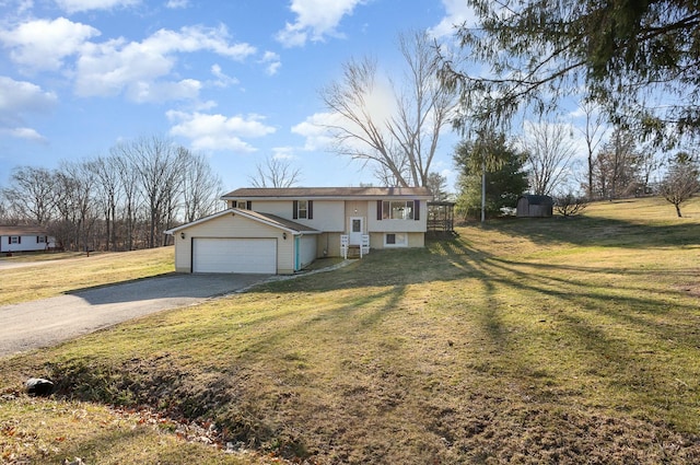 raised ranch featuring aphalt driveway, an attached garage, and a front yard