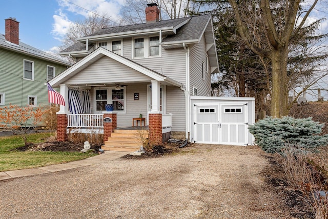 view of front of home featuring driveway, covered porch, a shingled roof, and a chimney