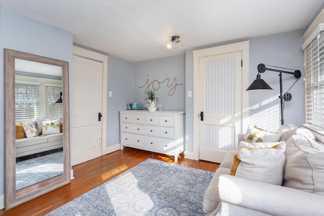 living area featuring wood finished floors and baseboards