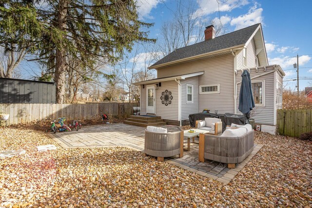 back of property featuring a patio area, fence, a chimney, and roof with shingles