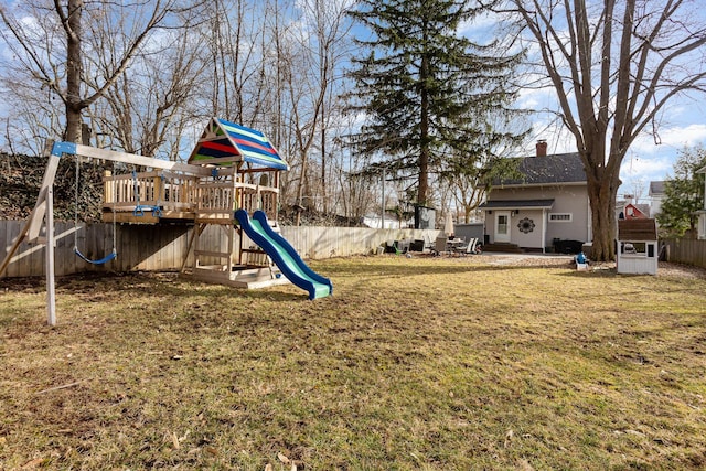 view of play area featuring a lawn and a fenced backyard