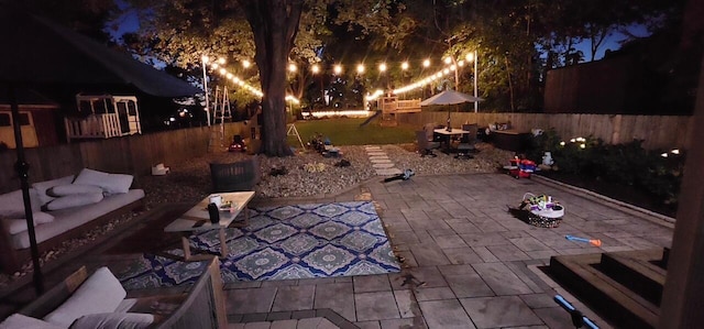 patio at twilight featuring fence