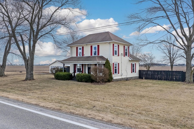 american foursquare style home featuring fence and a front lawn