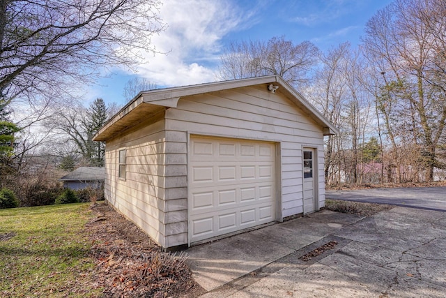 detached garage featuring driveway