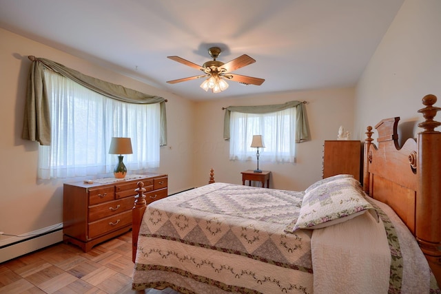 bedroom with a baseboard radiator and ceiling fan