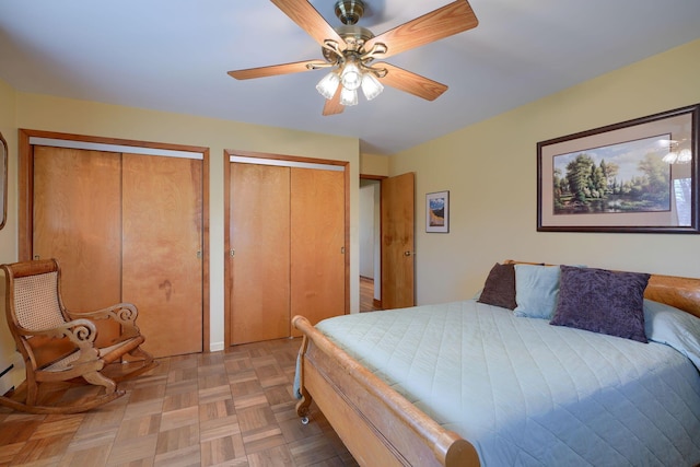 bedroom featuring multiple closets and a ceiling fan