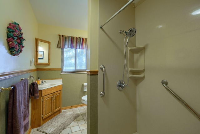 bathroom featuring vanity, walk in shower, toilet, and tile patterned floors