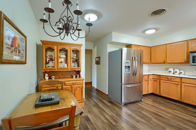 kitchen with dark wood-style floors, visible vents, stainless steel appliances, and light countertops