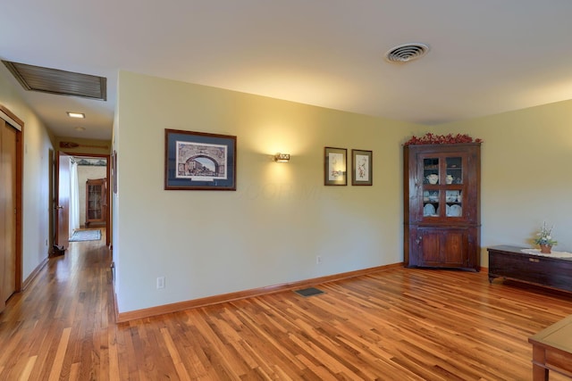 interior space with visible vents, baseboards, and wood finished floors