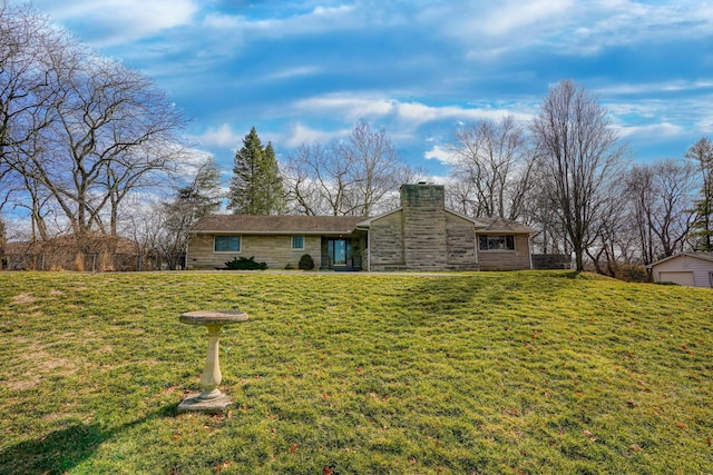 view of front of home with stone siding, a chimney, and a front lawn