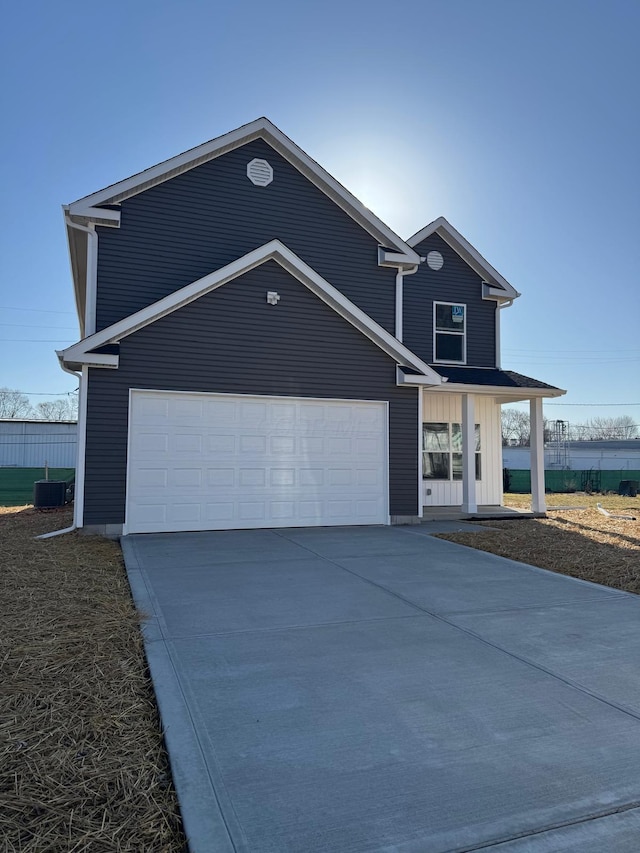 view of front of house featuring central air condition unit, a garage, concrete driveway, and fence