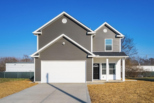 traditional home with driveway, a front yard, and a garage