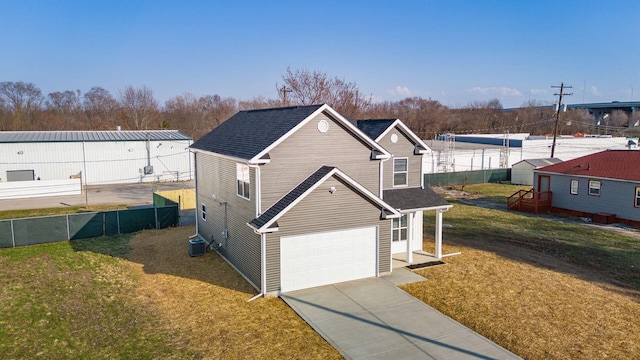 view of front of house featuring fence, a front yard, cooling unit, a garage, and driveway