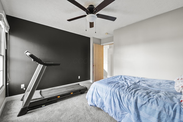 bedroom featuring a textured ceiling, ceiling fan, carpet flooring, and baseboards