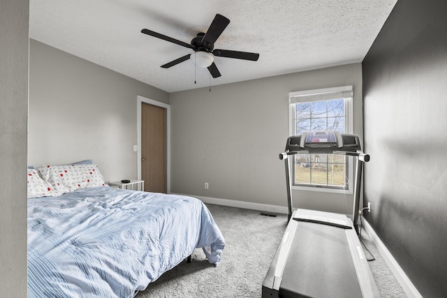 bedroom with visible vents, a ceiling fan, carpet flooring, a textured ceiling, and baseboards