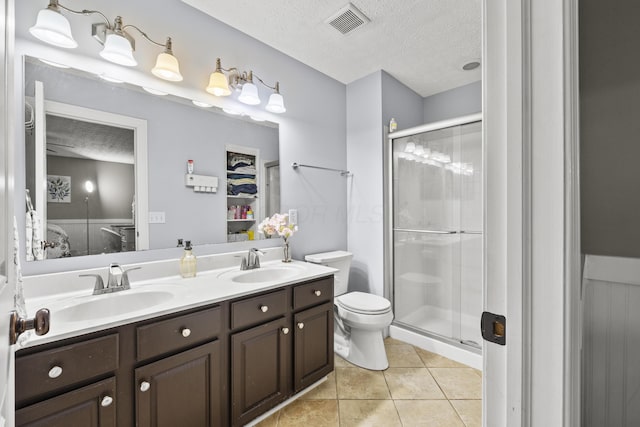 ensuite bathroom with a sink, a textured ceiling, and ensuite bath