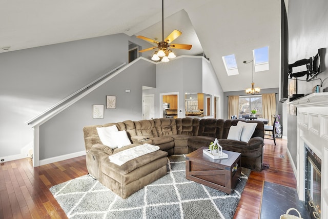 living area with a skylight, wood-type flooring, a fireplace with flush hearth, high vaulted ceiling, and baseboards