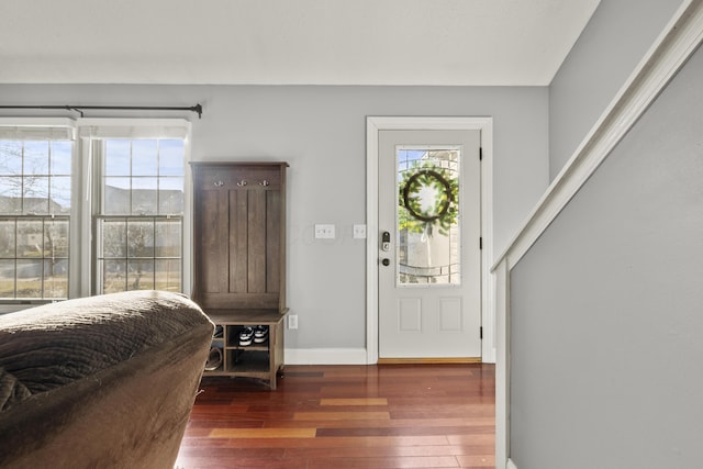 foyer featuring baseboards and wood finished floors