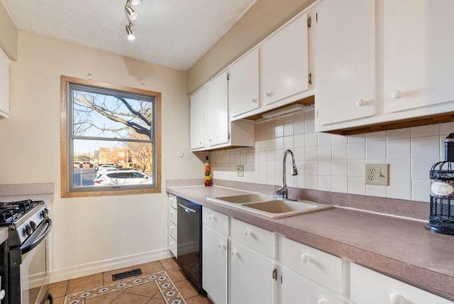 kitchen featuring light tile patterned floors, dishwasher, gas range, white cabinetry, and a sink