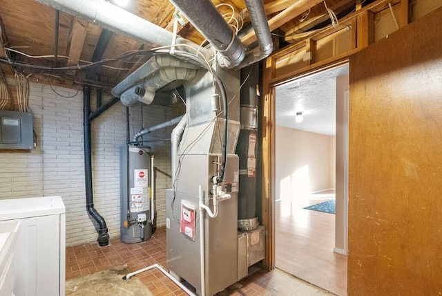 utility room with gas water heater and electric panel