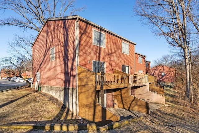 view of side of property featuring a deck