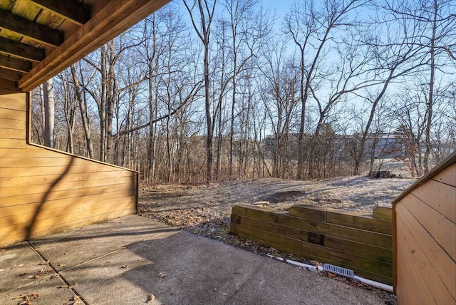 view of patio with a view of trees