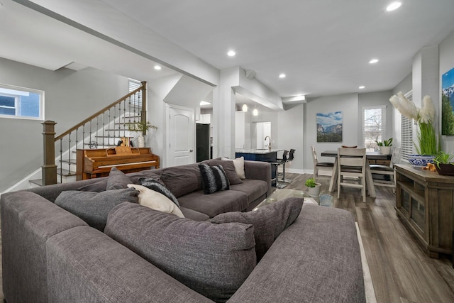 living room featuring stairs, recessed lighting, wood finished floors, and baseboards