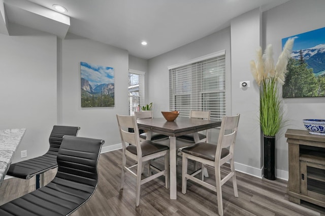 dining area featuring recessed lighting, baseboards, and wood finished floors