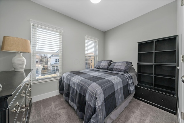 bedroom featuring baseboards and carpet floors