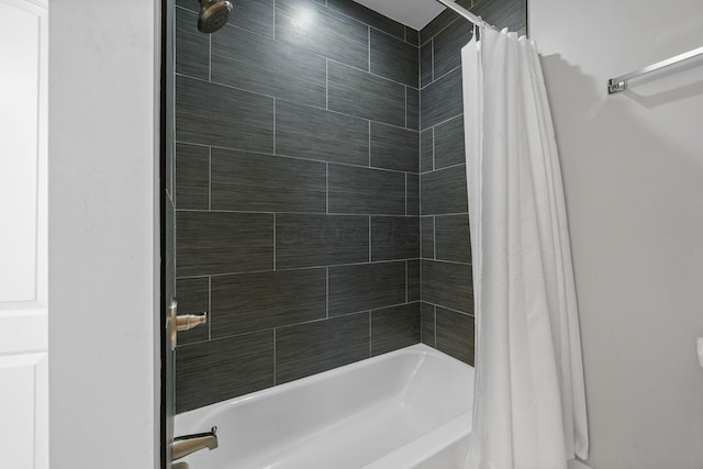 bathroom with shower / bath combo with shower curtain